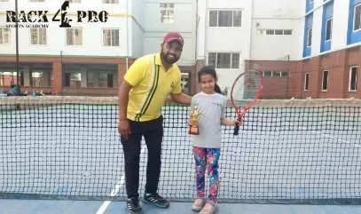 Coach celebrating with our talented lawn tennis player, Bhargavi Aditri, after her remarkable debut performance. This partnership between player and coach is the foundation of our success.