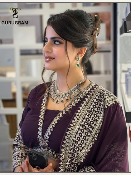 A profile view showing the details of the hair and makeup. The soft smokey eye and glowing skin create a look of timeless elegance.