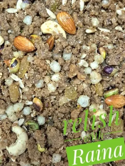 A close-up of the Panjiri, showing the mix of roasted flour, puffed gond, and whole nuts like almonds and cashews. It is as delicious as it is nutritious.