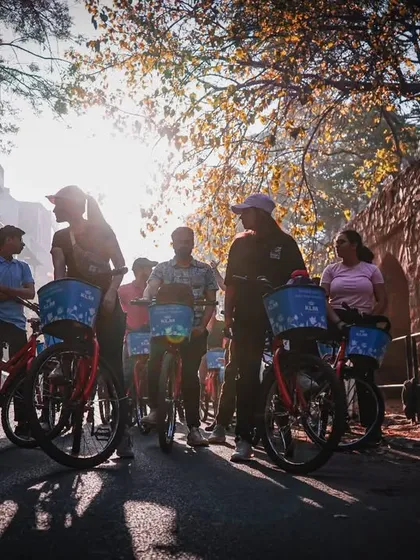 The morning sun casts a beautiful silhouette as our group gathers in a quiet lane. These peaceful moments are a beautiful contrast to the usual hustle of the city.