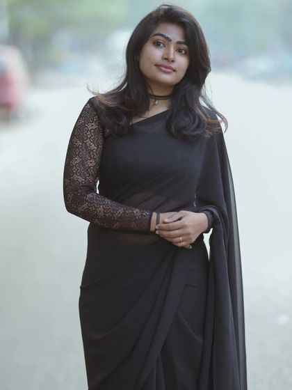 A full-length shot of the black saree look, showing how the simple makeup balances the entire outfit.