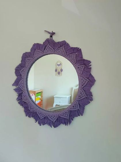 Reflecting the beauty of our clients' spaces. This purple macrame mirror looks perfect in this child's room, adding a pop of color and handmade charm.