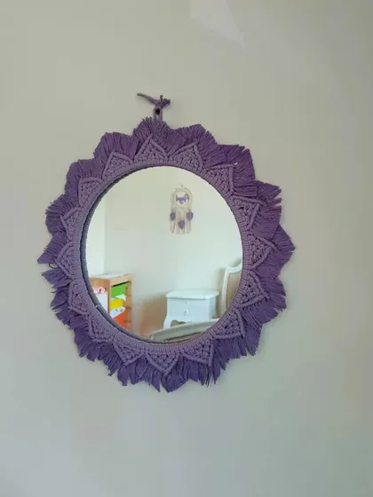 Reflecting the beauty of our clients' spaces. This purple macrame mirror looks perfect in this child's room, adding a pop of color and handmade charm.