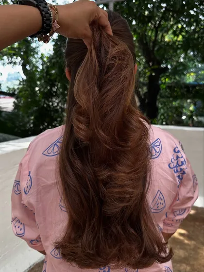 Nothing screams confidence like freshly colored hair. We went for a rich chocolate brown with subtle highlights, styled with big, bouncy waves for a glamorous finish.