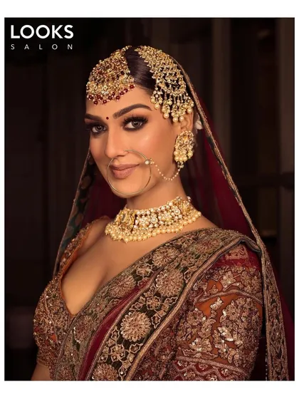 A smiling bride, ready for her big day. This look features a warm, glowing complexion and defined eyes, creating a perfect balance between traditional glam and a natural, happy radiance.