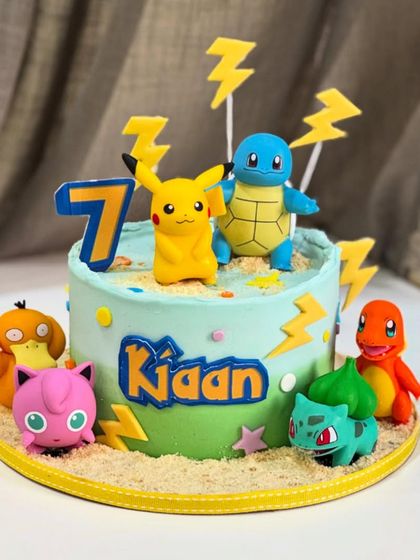 Gotta catch 'em all! This Pokémon-themed cake for a 7th birthday features Pikachu, Squirtle, and friends, all ready for a party. The edible characters and lightning bolts make it an adventure in every slice.