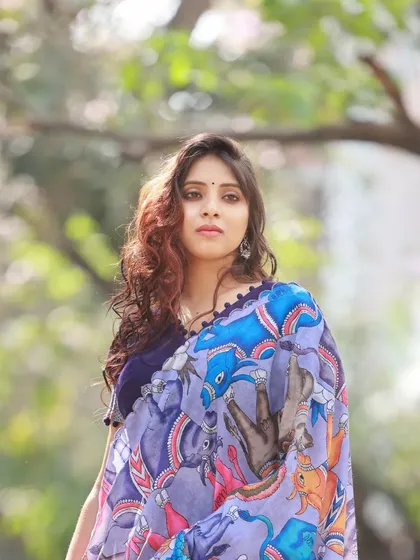 A portrait from our admiral blue half-saree shoot, with the model looking over her shoulder. The natural light and soft background create a dreamy, romantic feel.