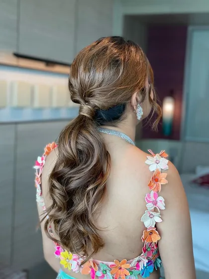 The final look is a textured, mid-height ponytail. It's a simple yet elegant style that doesn't need any accessories to make a statement.