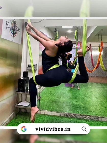 Fly high and live vibrant. This student showcases a beautiful split in the hammock, a testament to the flexibility that can be achieved with consistent practice.