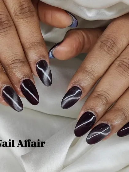 A deep, dark burgundy cat eye manicure for a mysterious and sophisticated look.