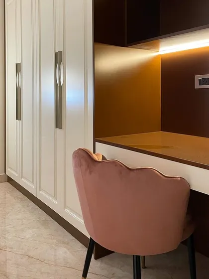 A compact study nook integrated into the wardrobe unit in the 'Rose' room. This provides a dedicated workspace without requiring a separate room.