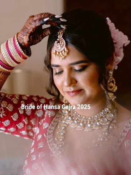 A stunning bride getting ready on her big day. Her intricate mehendi is a key part of her regal look, complementing her beautiful jewelry and outfit.