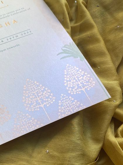 A detail shot of the pearl-finish paper, which has a beautiful, subtle shimmer. The rose gold foil stamping of the tree motifs catches the light beautifully.