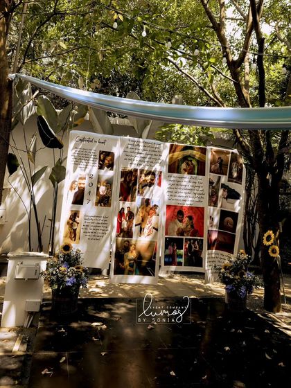 A "Love Story Corner" at a Haldi ceremony, showcasing the couple's journey through photos and stories on a large display.