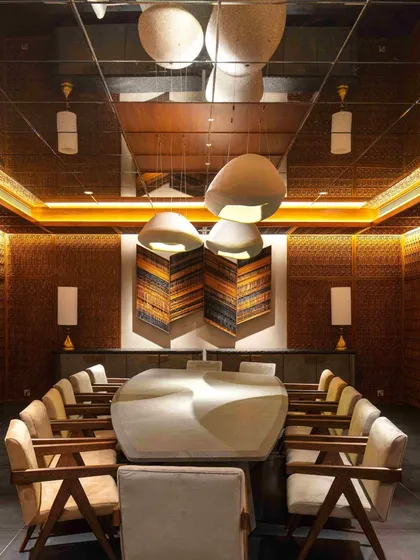 The Bammi Residence dining room, where a mirrored ceiling and strategic lighting create a dramatic and immersive experience. The design proves that even a basement can become a home's centerpiece.