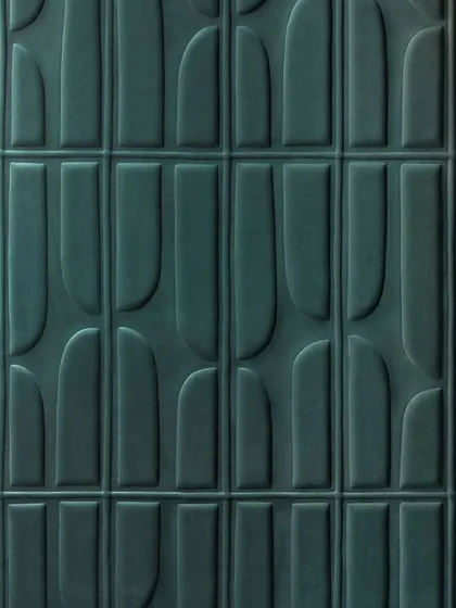A close-up of our "Le sentier des effluves" 3D wallcovering. The fusion of suede texture and geometric patterns gives rise to a multidimensional landscape of gentle, quilted shapes in a deep teal.