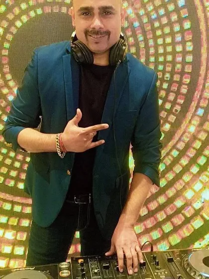 A good party is all about the right energy. Here I am behind the decks, ready to mix up a storm of Bollywood, Punjabi, and retro hits for a fantastic crowd.