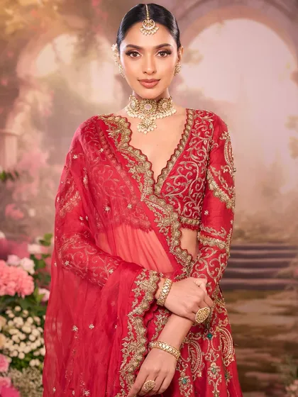 A gorgeous bride in a classic red outfit. We styled her with a sleek bridal bun and a soft, bronze-toned makeup look for a truly timeless feel.