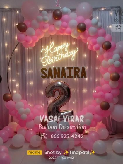 A classic Minnie Mouse theme for a second birthday. We used a pink and white color scheme with a circular backdrop, a neon sign, and adorable Minnie Mouse balloon pillars to create a sweet and charming party setting.