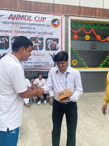 Exchanging tokens of appreciation with officials at our Anmol Cup. Building a strong taekwondo community is a key part of our mission.