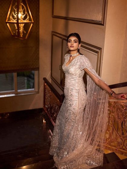 The full-length view of this stunning engagement gown. The silhouette is designed to be flattering and dramatic, making a statement from the moment she walks into the room.