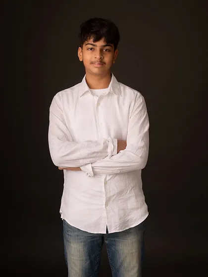 A more formal pose with arms crossed, showing a different side of his personality. Classic portraits are great for capturing the nuances of older children.