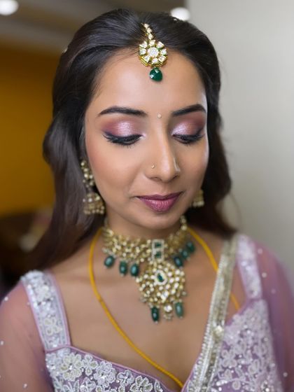 My stunning bride Manasa for her reception. We created a soft glam look with shimmery pink-purple eyes to match her beautiful lehenga.