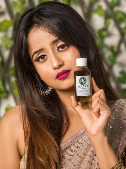 A stunning shot of my "Pure Bliss" hair oil. It's infused with coconut oil, castor oil, hibiscus, and aloe vera to thicken your hair and give you amazing volume.
