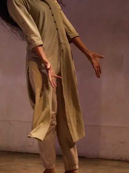 A detail shot of my movement in "DANDYLION." The flow of the costume and the gesture of my hands are part of the physical storytelling.