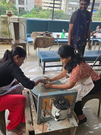 A glimpse of a daytime session on the terrace. You can see the open-air setup, with participants working on the wheel against the backdrop of the city.