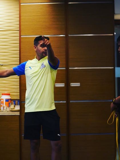 Explaining a drill to a player during a training session. Clear and concise communication is key.