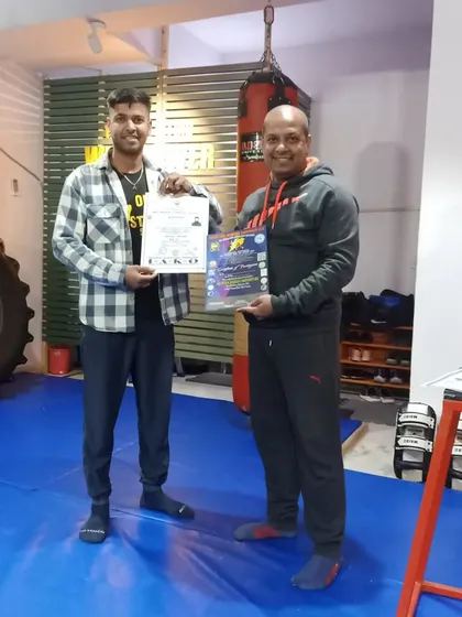 Coach Sandeep proudly displaying his new Black Belt and National Referee certifications.