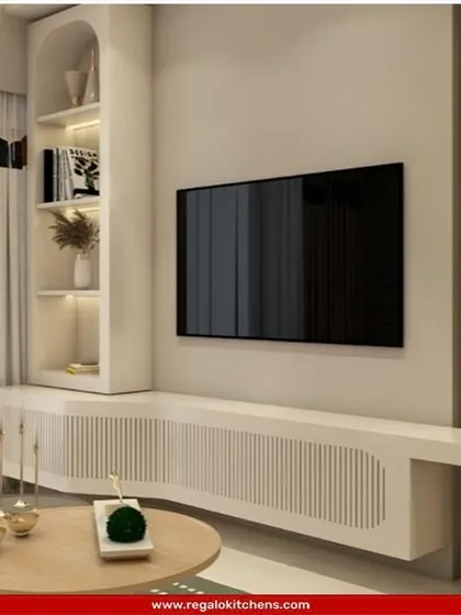 A soft and minimalist TV unit with a curved console and arched open shelving. The light wood and white color palette creates a calm and inviting atmosphere.