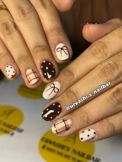The perfect "Latte Girl" aesthetic. This cozy set features hand-painted bows, polka dots, and plaid patterns in shades of chocolate brown and cream for a look that's timelessly chic.