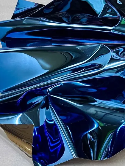 A detail of "Meteor 119," showing how the light catches the sharp edges of the folds, creating highlights that define its form.