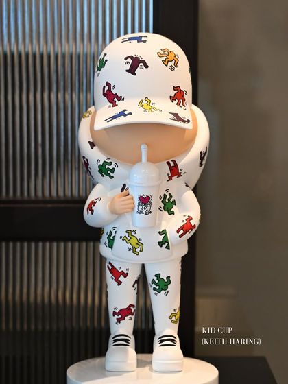 The "Kid Cup" series by Leo and Steph, featuring a figure in a Keith Haring-inspired outfit. This piece is a fusion of street charm and pop artistry, wrapped in nostalgia and modern flair.