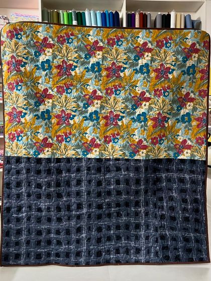 The back of the Jelly Roll quilt, featuring two different fabrics.