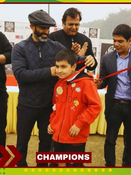 A young player beams with pride as he receives his medal. We believe in encouraging our players every step of the way.