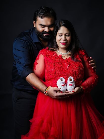 We love incorporating meaningful props into your shoot. Here, the couple holds a tiny pair of baby shoes, a touching symbol of the little one they are so excited to meet.