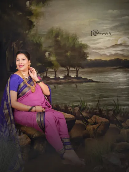 A Raja Ravi Varma-inspired studio portrait, with the mother-to-be seated gracefully in a traditional nauvari saree.