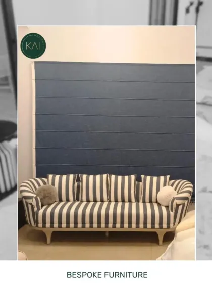 This bold, striped sofa with its curved arms and light wood legs makes a definite style statement. It's a perfect example of how we use distinctive fabrics to create standout pieces that bring energy and character to a room.