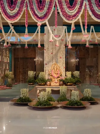 A grand entrance hall decorated with massive walls of white and pink flowers. This is how I make a statement from the moment guests arrive, enveloping them in luxury and beauty.