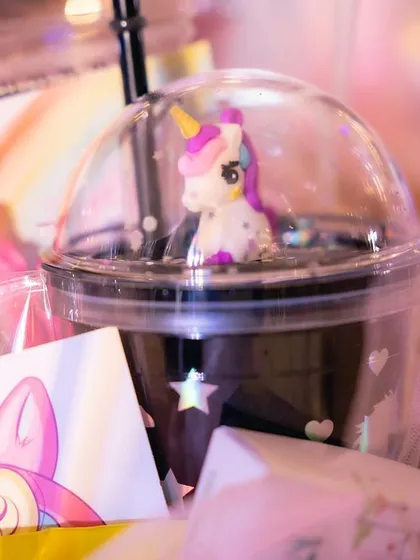 Even the smallest details are custom. This unicorn-themed party favor includes a cup with a miniature unicorn figure inside the dome lid.