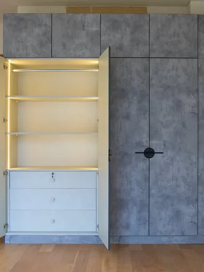 True luxury is in the details. This wardrobe features a modern concrete finish on the outside, but opens to reveal a warm, linen-textured interior with perfectly placed LED lighting. It’s a smart storage solution designed for real life, making your daily routine feel a little more special.