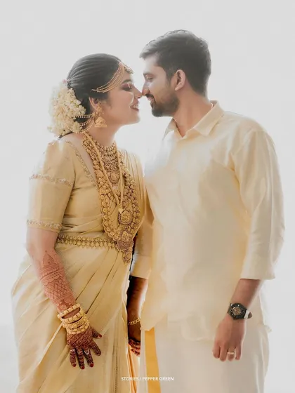 An intimate portrait of the couple about to kiss, their faces illuminated by a soft, bright light.