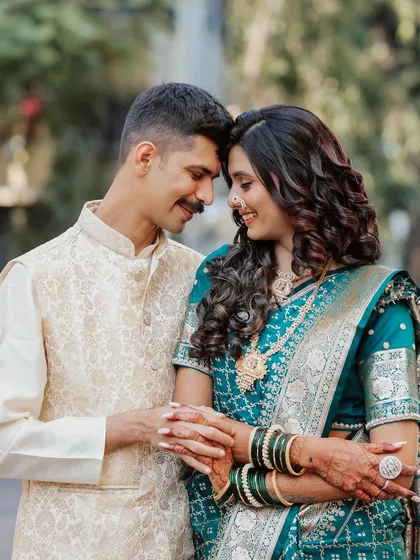 A beautiful engagement portrait. The couple's coordinated outfits and the bride's soft, glowing makeup create a harmonious and romantic look.