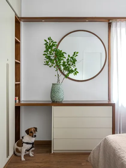 This custom dresser in the 'Pepper and Coffee' project combines a chest of drawers with a vanity table and open shelving, all framed in warm wood.
