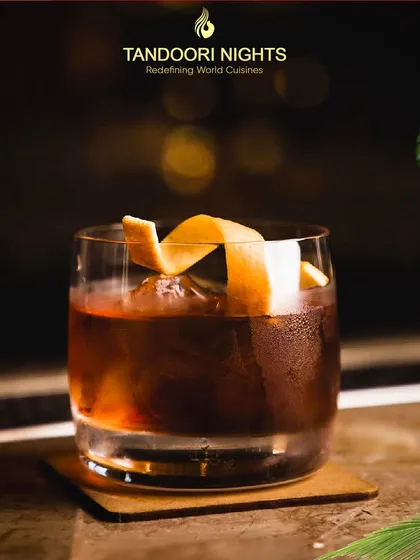 Summer in a glass. Experience the taste of sunshine with our irresistible drink selection, including classic cocktails like this Old Fashioned with an orange peel twist.