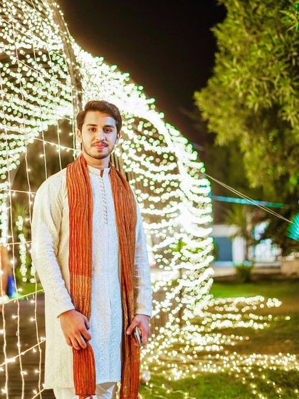 A nighttime shot of the same client. The makeup holds up perfectly under the decorative lights, giving him a subtle glow that looks fantastic in photos.