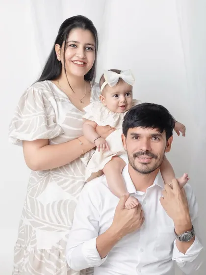 A sweet family portrait with their baby girl on dad's shoulders. The neutral outfits look so elegant and timeless.